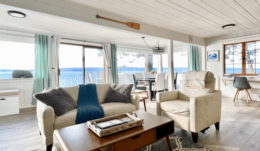 Open-concept living and dining area with modern furnishings and ocean views