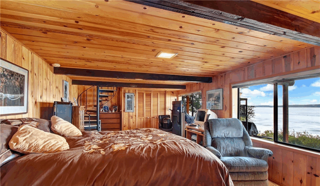 Warm-toned bedroom with wood-paneled walls and a plush bed